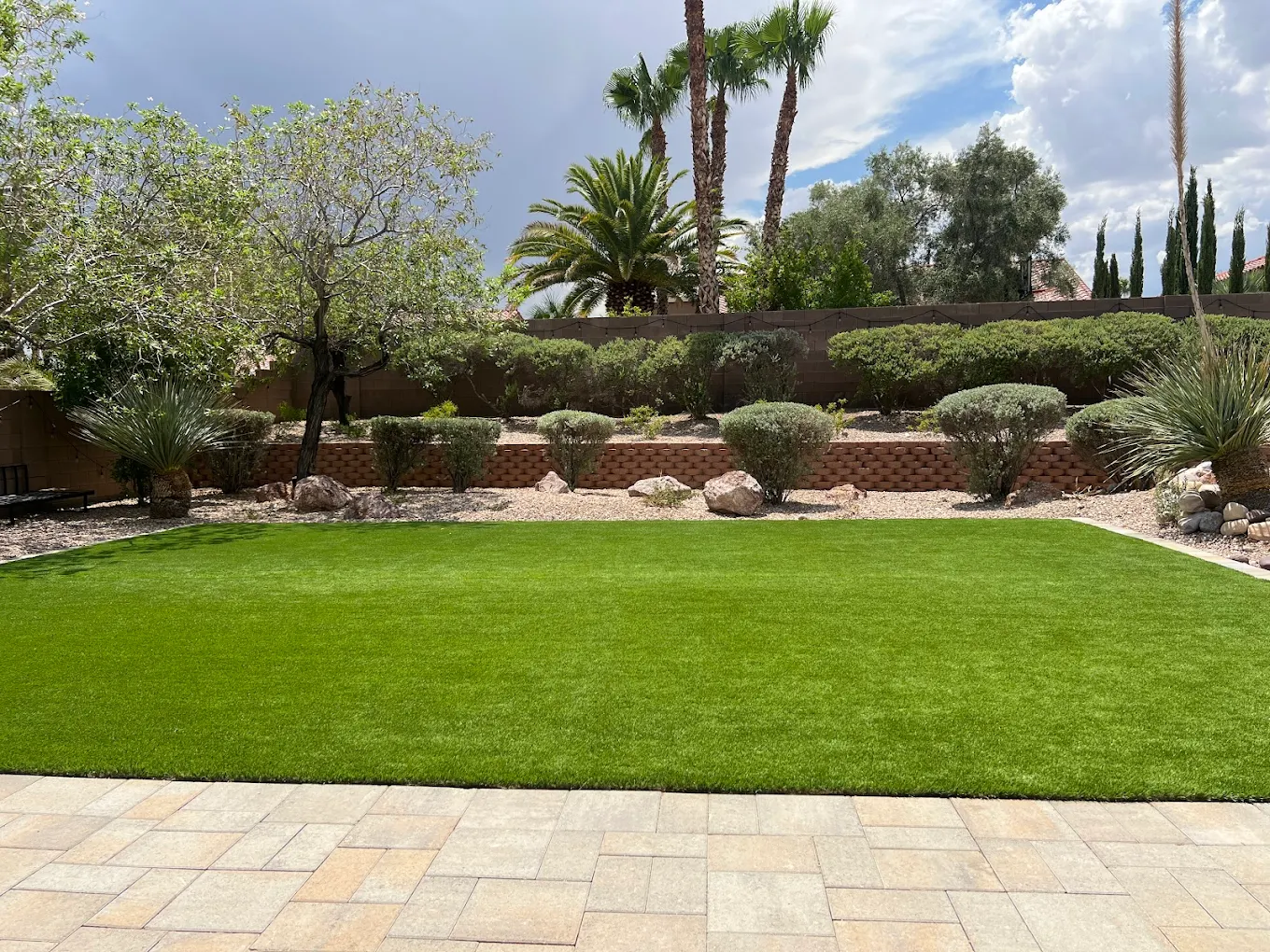 Well-maintained artificial turf front yard in a San Diego HOA community with native landscaping