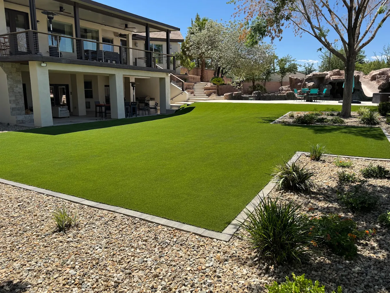 Professionally installed artificial turf in a luxury San Diego backyard with outdoor living features