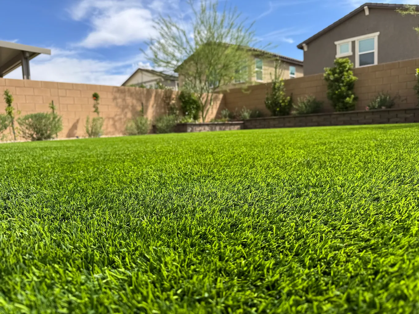 Close-up of commercial artificial turf fibers in pristine condition at a San Diego property