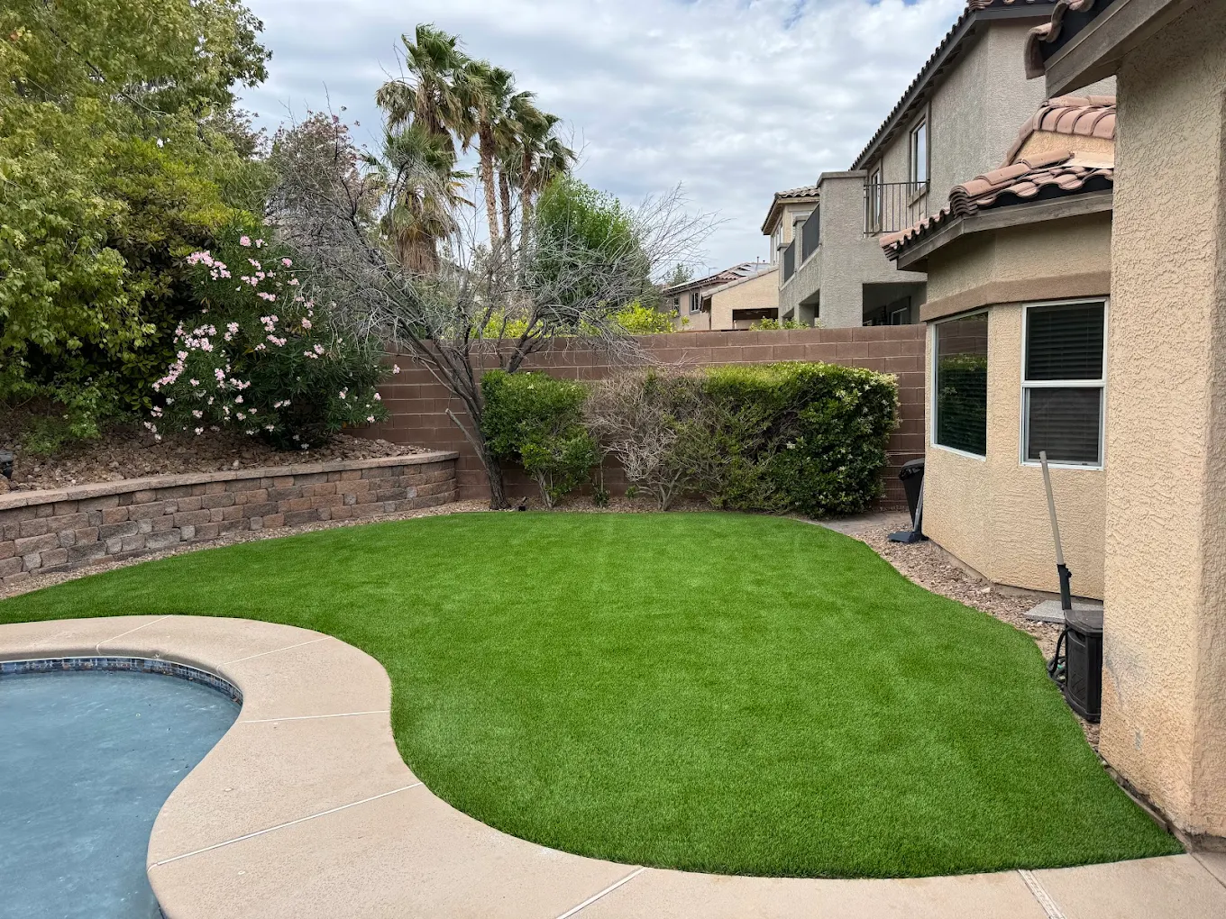 Artificial turf next to pool area in San Diego County home